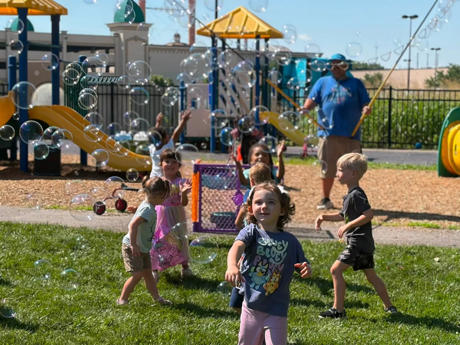 Children chasing bubbles together on the Northland playground