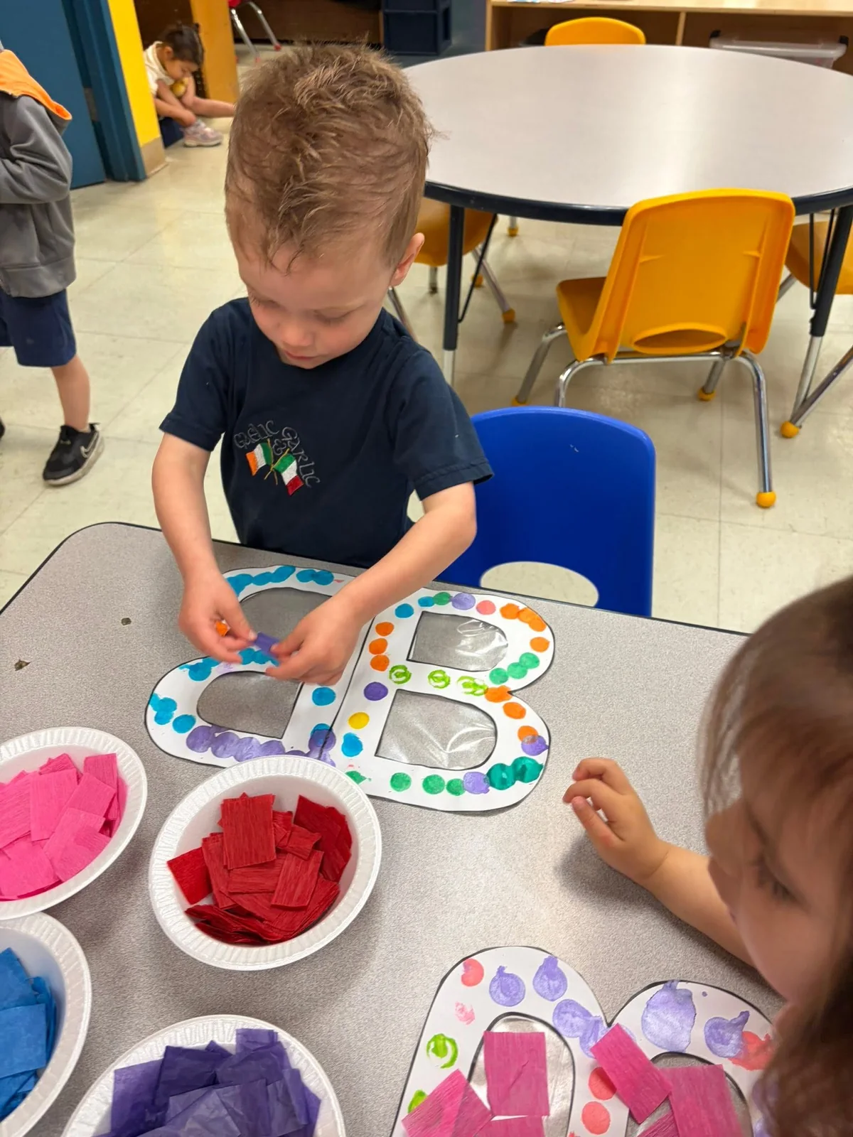 Children creating colorful artwork together at a Northland classroom table